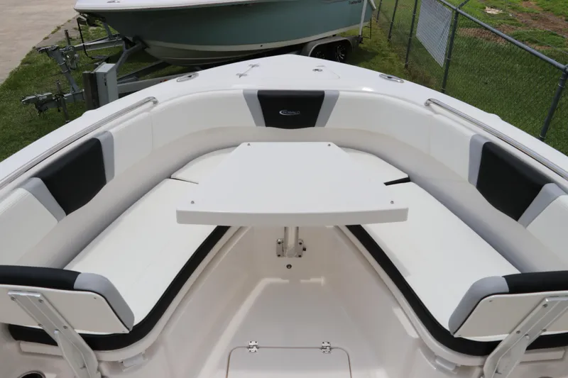 Slide: The Image of 2024 Robalo R230 Center Console boat interior with seating and table. - 27