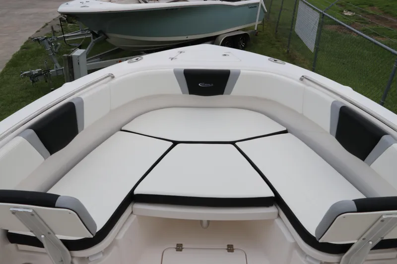 Slide: The Image of 2024 Robalo R230 Center Console boat with cushioned seating area. - 28