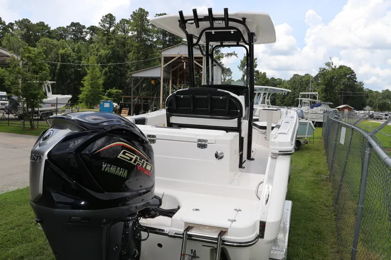 Slide: The Image of 2024 Robalo R230 Center Console boat with Yamaha engine, parked outdoors. - 3