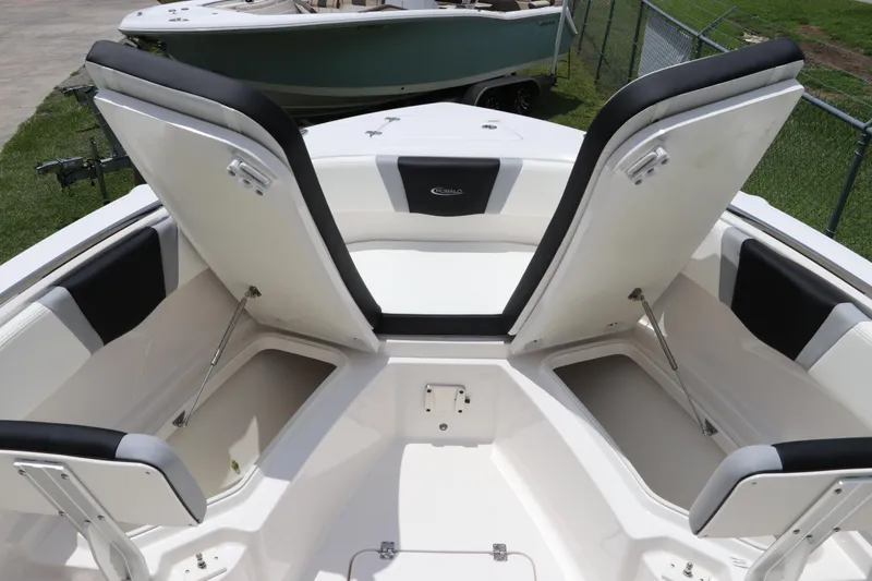 Slide: The Image of 2024 Robalo R230 Center Console boat with open storage compartments and cushioned seating. - 30
