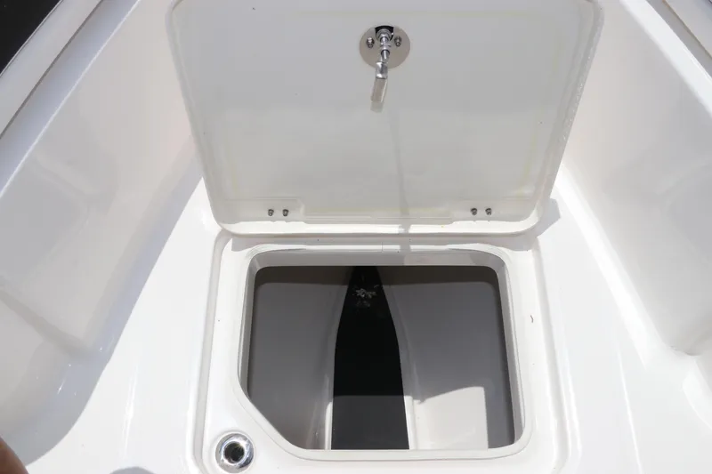 Slide: The Image of 2024 Robalo R230 Center Console storage compartment with open lid. - 33