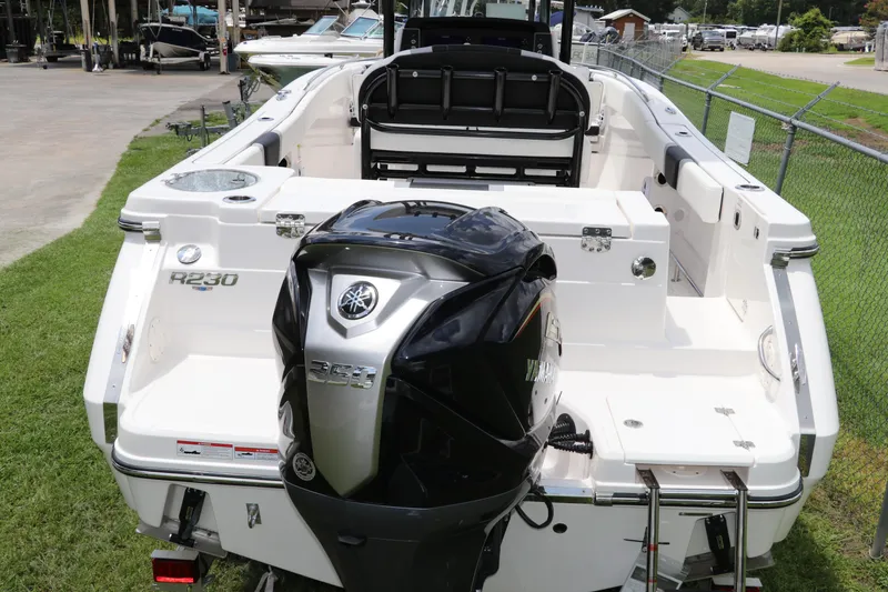 Slide: The Image of 2024 Robalo R230 Center Console boat with Yamaha engine, docked on grass. - 4