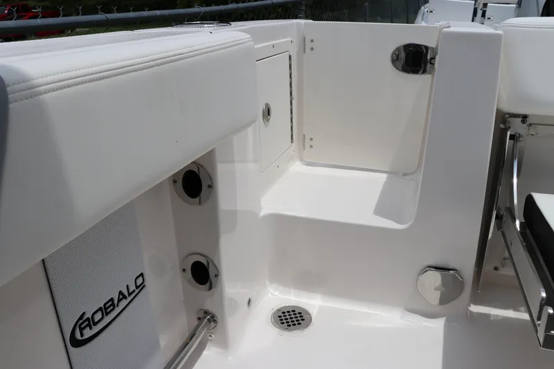 Slide: The Image of 2024 Robalo R230 Center Console boat interior with storage compartment and seating. - 5