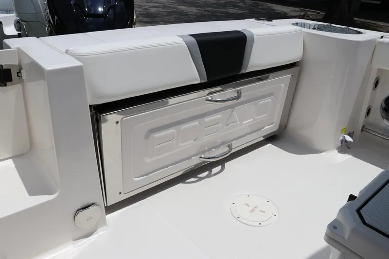 Slide: The Image of 2024 Robalo R230 Center Console boat interior with storage compartment and seating. - 7