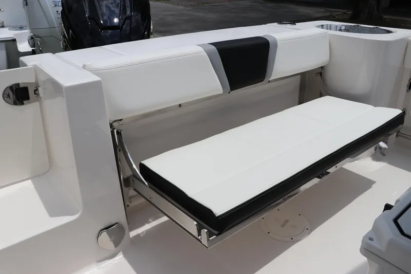 Slide: The Image of 2024 Robalo R230 Center Console boat with foldable white seating. - 8