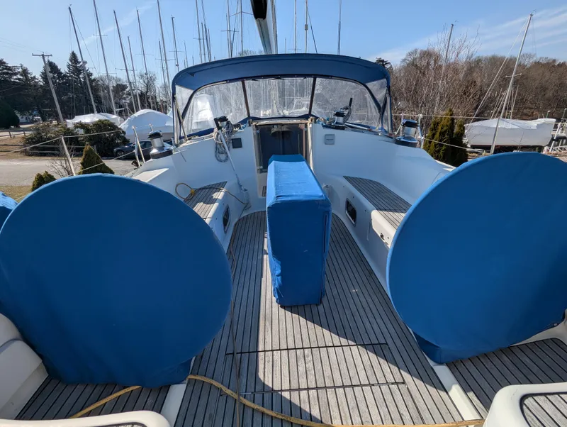 Slide: The Image of Jeanneau 45.1 sailboat cockpit with blue covers, 1996 model, docked in a marina. - 16