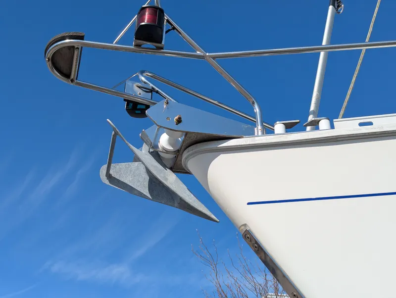 Slide: The Image of Bow of 1996 Jeanneau 45.1 sailboat with anchor against clear blue sky. - 18