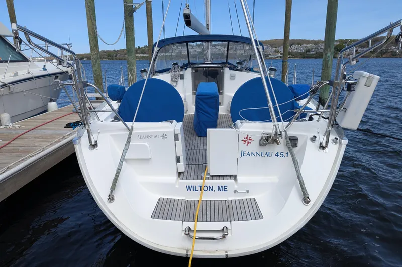 Slide: The Image of Sailboat Jeanneau 45.1, 1996 model, docked at marina with blue seating. - 2