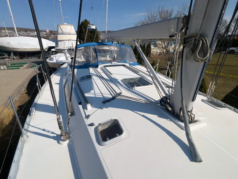 Slide: The Image of 1996 Jeanneau 45.1 sailboat on land, showcasing deck and rigging. - 21