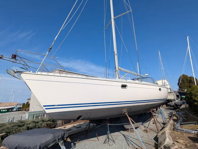 Slide: The Image of Sailboat Jeanneau 45.1 from 1996 on dry dock under clear blue sky. - 3
