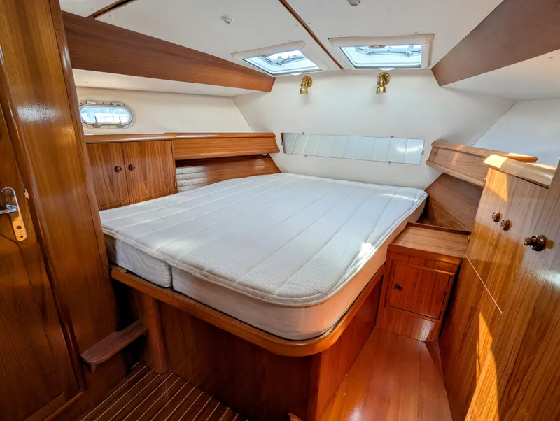 Slide: The Image of Cozy cabin interior of 1996 Jeanneau 45.1 sailboat with wooden furnishings and skylights. - 31