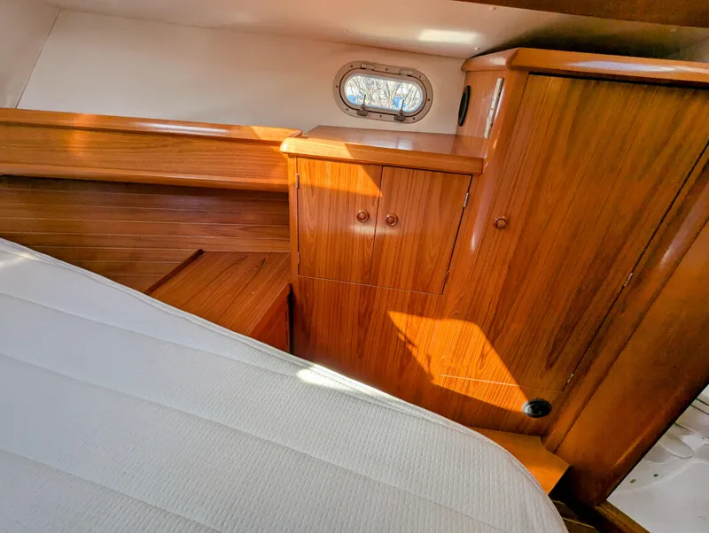 Slide: The Image of Cozy cabin interior of 1996 Jeanneau 45.1 sailboat with wooden cabinetry and porthole. - 33