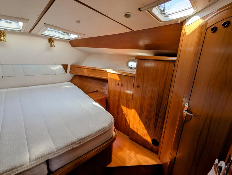 Slide: The Image of Cozy cabin interior of 1996 Jeanneau 45.1 yacht with wooden furnishings and natural light. - 35