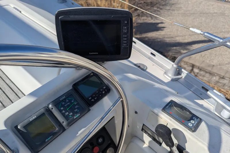 Slide: The Image of Cockpit of 1996 Jeanneau 45.1 sailboat with navigation instruments and steering wheel. - 4