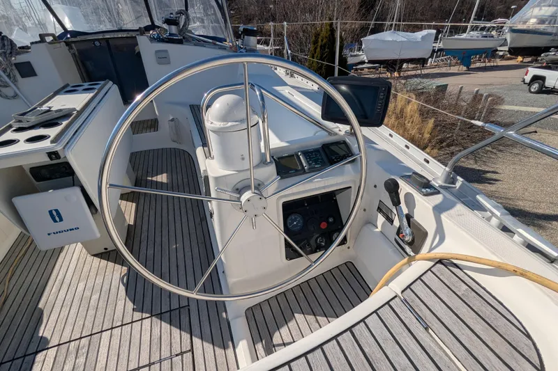 Slide: The Image of Cockpit of 1996 Jeanneau 45.1 sailboat with steering wheel and navigation controls. - 8