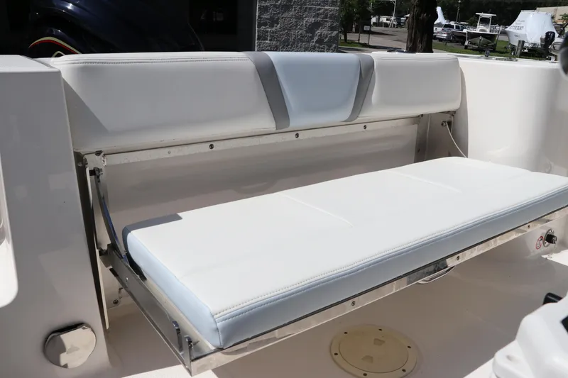 Slide: The Image of 2024 Robalo R230 Center Console boat with white foldable bench seat. - 12