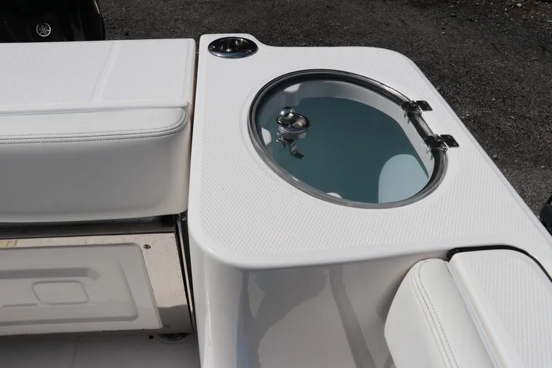 Slide: The Image of 2024 Robalo R230 Center Console boat with livewell and seating area. - 13