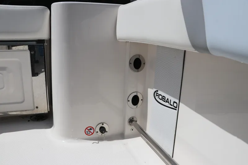 Slide: The Image of 2024 Robalo R230 Center Console boat interior detail with logo and fittings. - 15