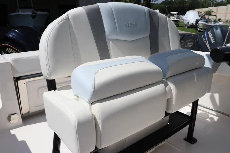 Slide: The Image of 2024 Robalo R230 Center Console boat seating with cushioned backrest and armrests. - 17