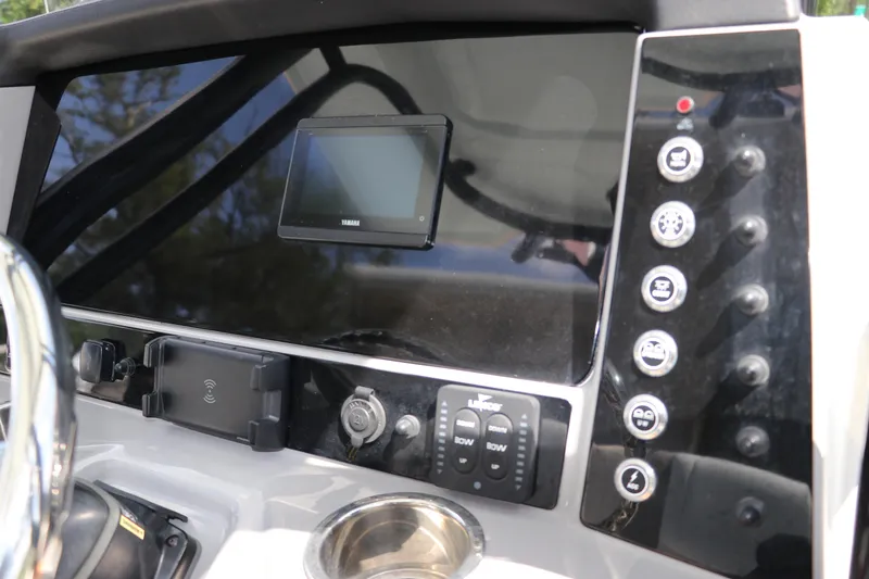 Slide: The Image of 2024 Robalo R230 Center Console dashboard with controls and display screen. - 22