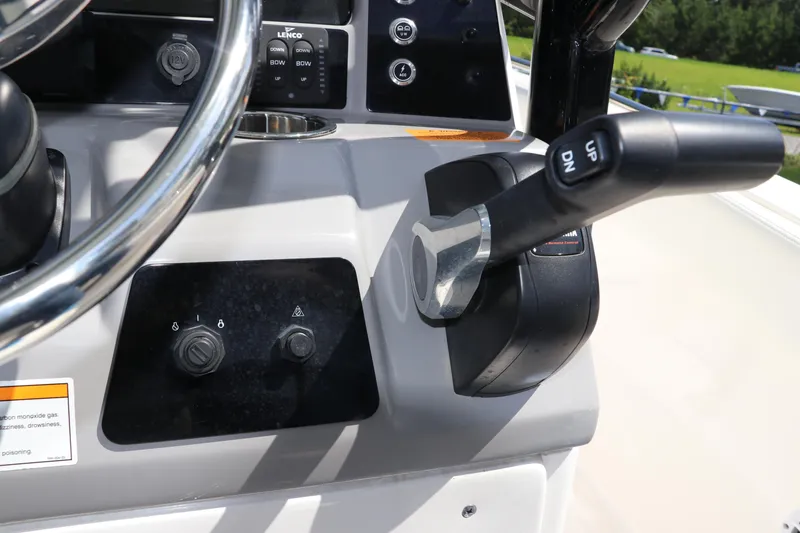 Slide: The Image of 2024 Robalo R230 Center Console boat controls and steering wheel close-up. - 24