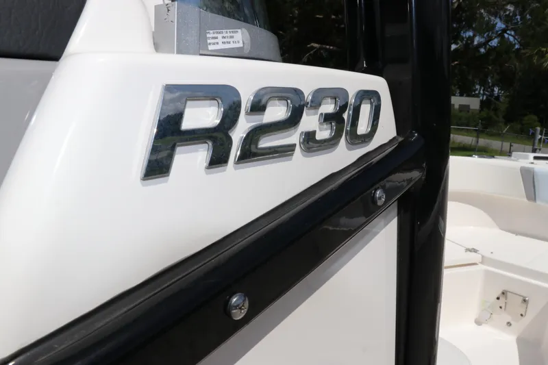 Slide: The Image of 2024 Robalo R230 Center Console boat emblem close-up. - 28