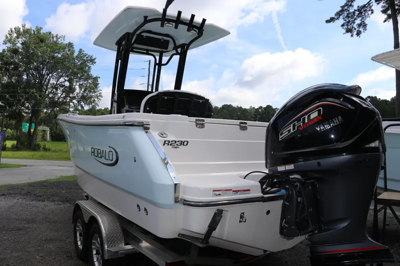 Slide: The Image of 2024 Robalo R230 Center Console boat with Yamaha engine, parked outdoors. - 3