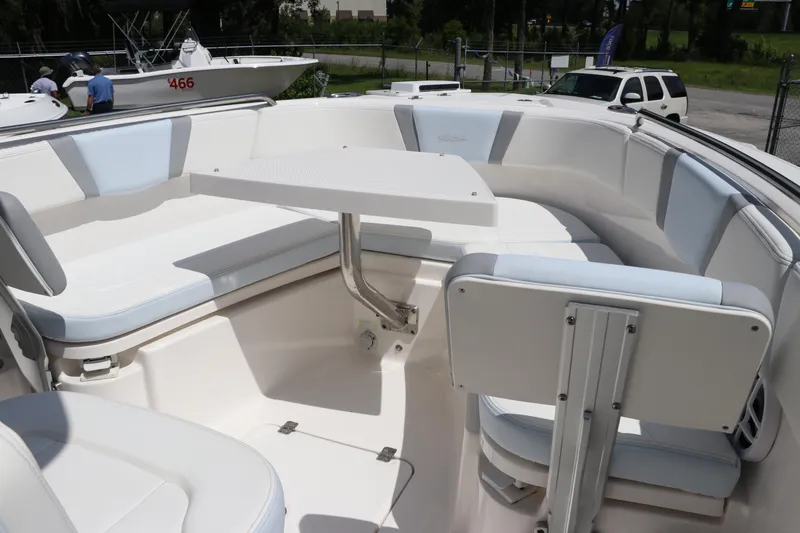 Slide: The Image of 2024 Robalo R230 Center Console boat interior with seating and table. - 35