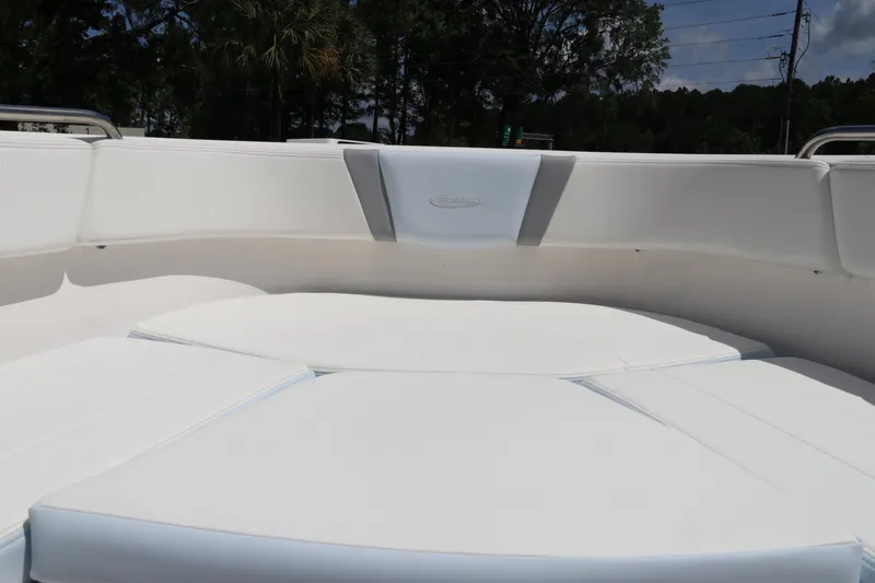 Slide: The Image of 2024 Robalo R230 Center Console boat with white cushioned seating area. - 36