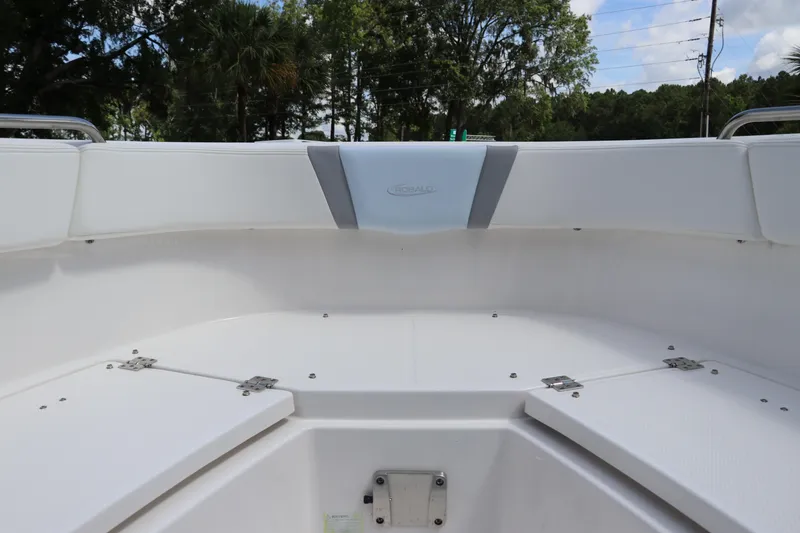 Slide: The Image of 2024 Robalo R230 Center Console boat interior with white seating and storage compartments. - 38