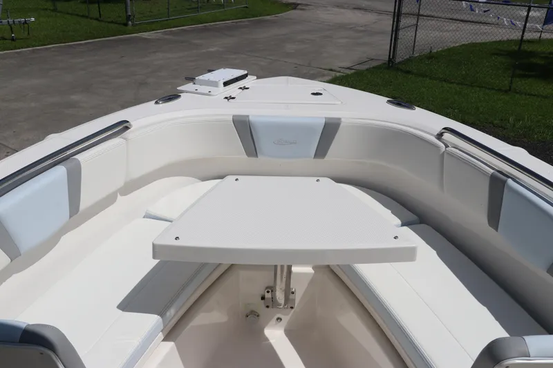 Slide: The Image of 2024 Robalo R230 Center Console boat interior with seating and table. - 39