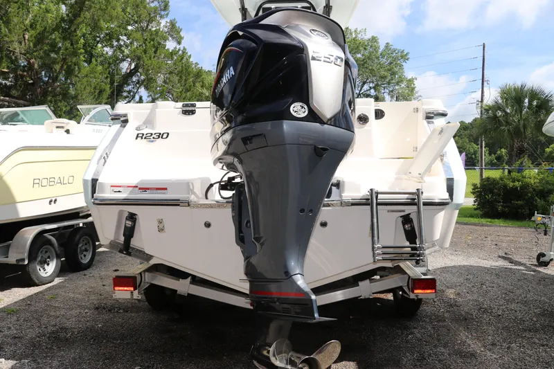 Slide: The Image of 2024 Robalo R230 Center Console boat with Yamaha outboard motor, parked outdoors. - 4