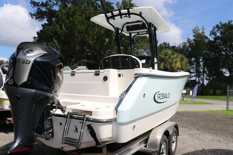 Slide: The Image of 2024 Robalo R230 Center Console boat on trailer, featuring Yamaha 250 engine, outdoors. - 5
