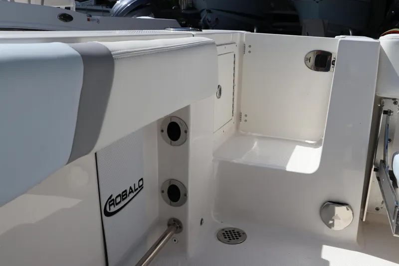 Slide: The Image of 2024 Robalo R230 Center Console boat interior, featuring sleek white design and storage compartments. - 9