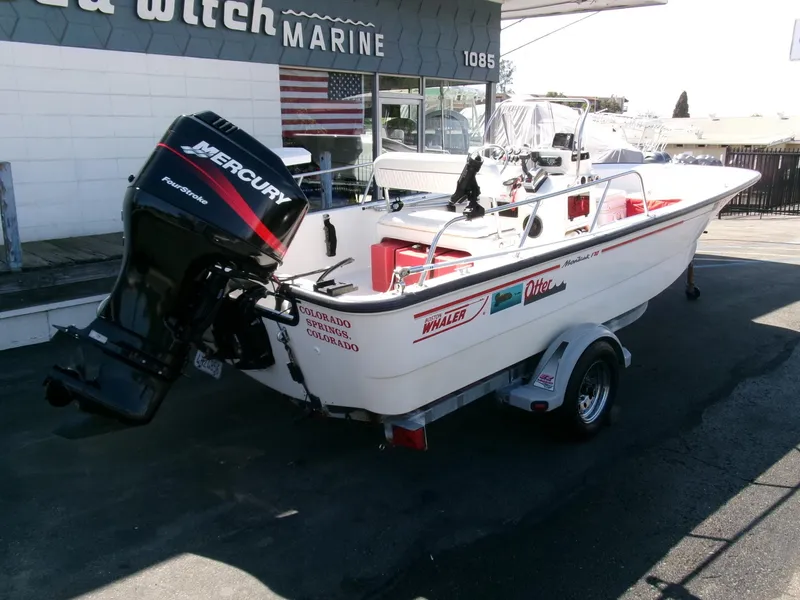 Slide: The Image of 2003 Boston Whaler 170 Montauk boat with Mercury outboard motor on trailer. - 1