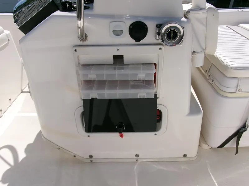 Slide: The Image of 2003 Boston Whaler 170 Montauk boat console with storage compartments and seating. - 10