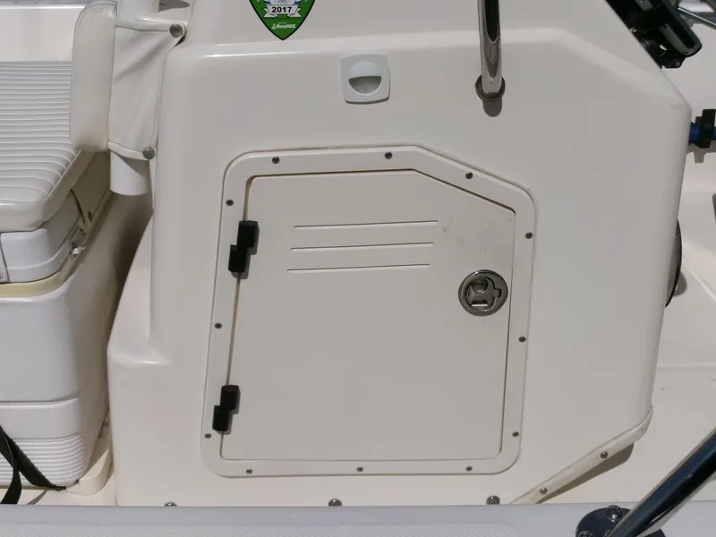 Slide: The Image of 2003 Boston Whaler 170 Montauk boat console with storage compartment and seating. - 11