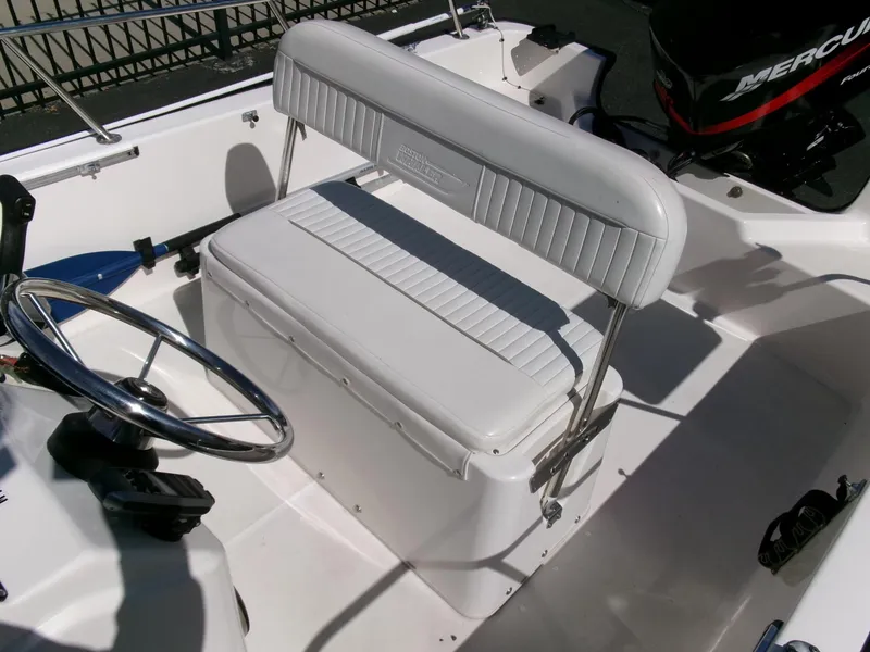 Slide: The Image of 2003 Boston Whaler 170 Montauk boat interior with steering wheel and seating. - 14