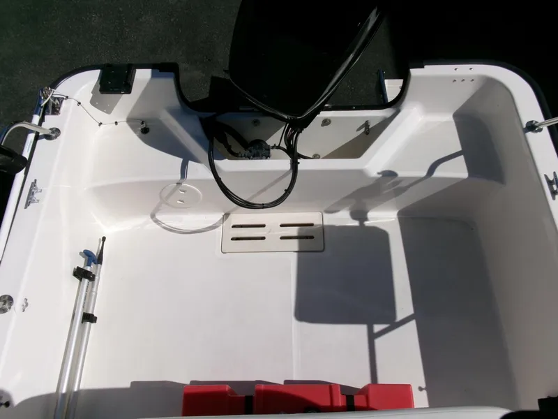 Slide: The Image of 2003 Boston Whaler 170 Montauk boat interior, featuring clean white deck and storage compartments. - 16