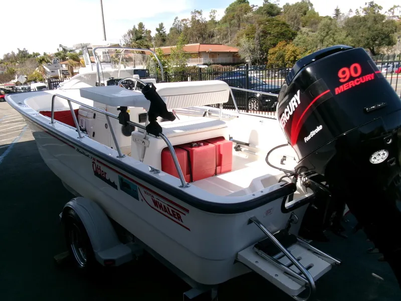 Slide: The Image of 2003 Boston Whaler 170 Montauk boat with Mercury 90 engine, parked on a trailer. - 2
