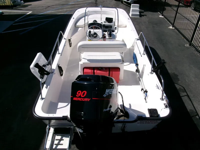 Slide: The Image of 2003 Boston Whaler 170 Montauk boat with Mercury 90 engine, docked in a marina. - 23