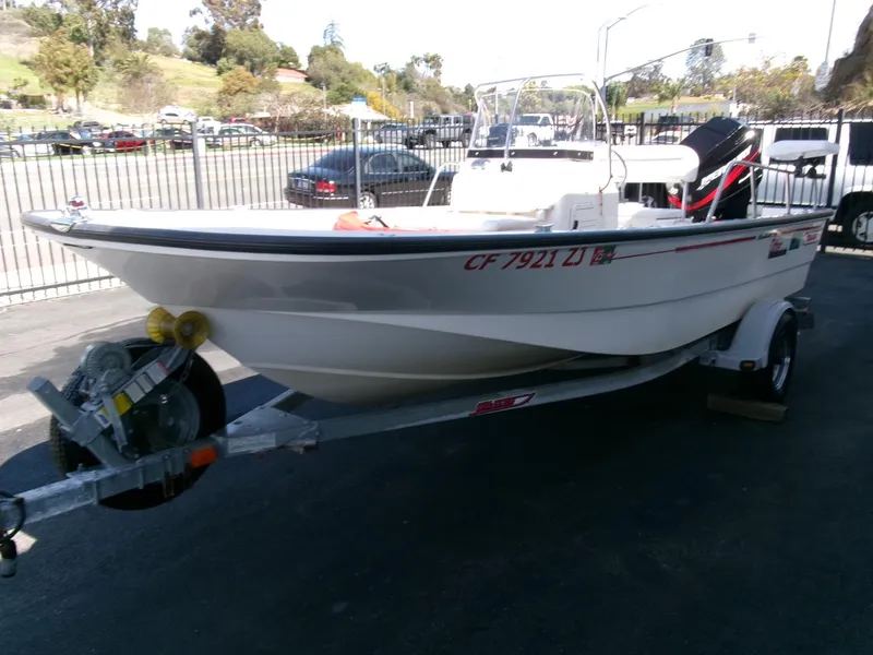 Slide: The Image of 2003 Boston Whaler 170 Montauk boat on trailer in parking lot. - 3