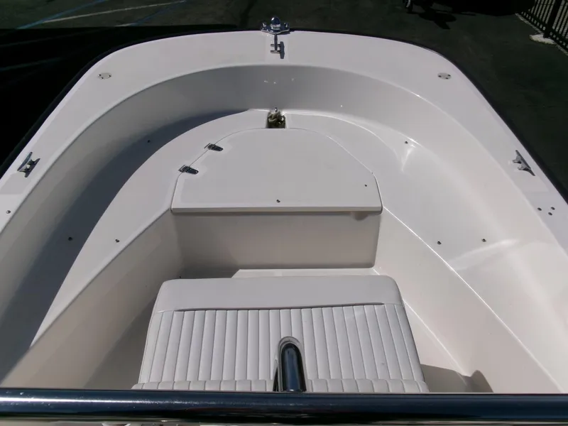 Slide: The Image of 2003 Boston Whaler 170 Montauk boat interior, featuring seating and storage area. - 5