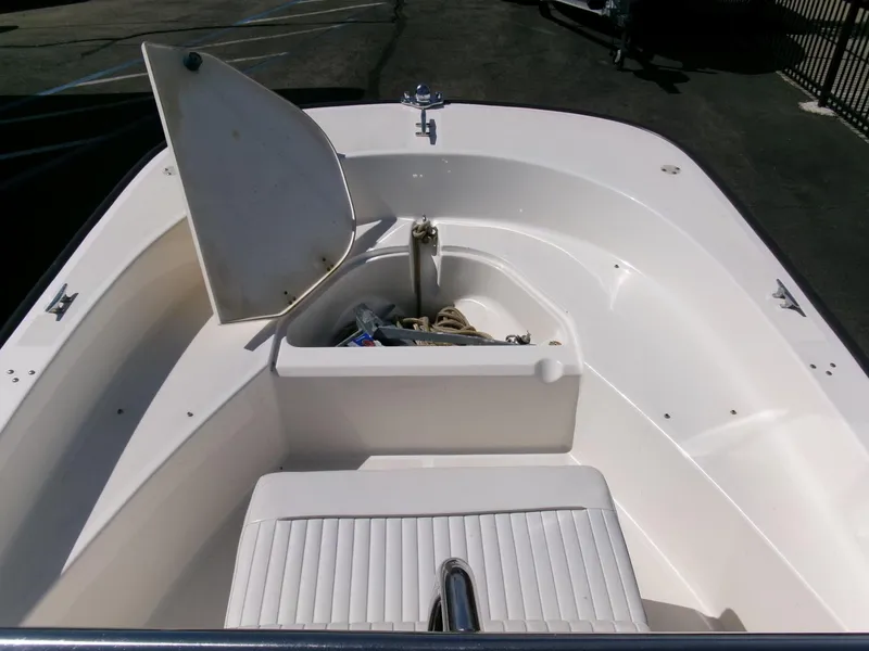 Slide: The Image of 2003 Boston Whaler 170 Montauk boat interior with open storage compartment. - 6