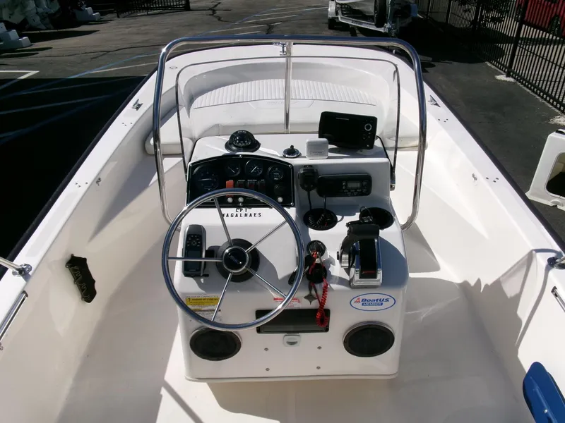 Slide: The Image of 2003 Boston Whaler 170 Montauk boat console with steering wheel and controls. - 8