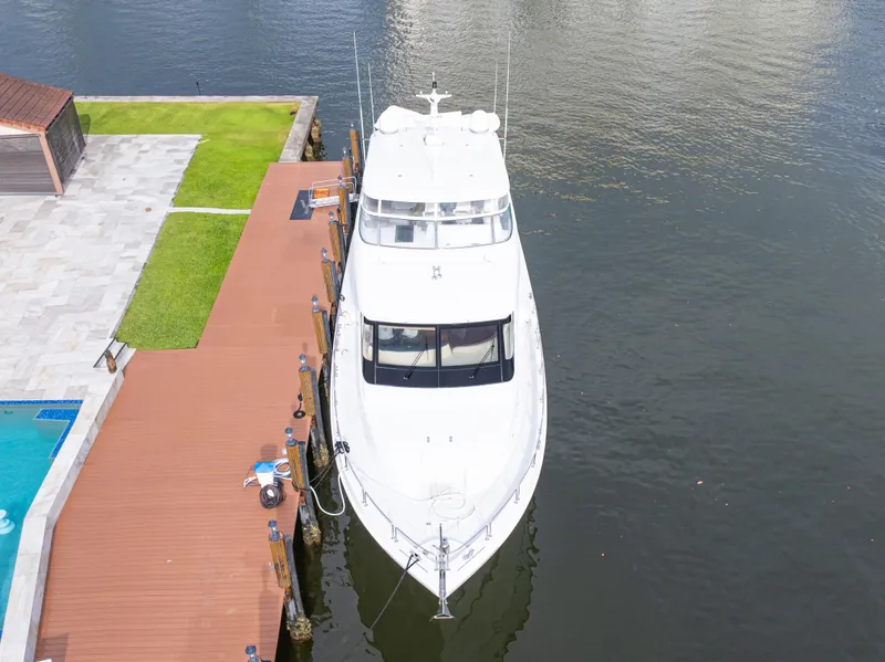 Slide: The Image of 2005 Hatteras 80 Motor Yacht docked by waterfront with pool and patio. - 10