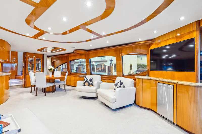 Slide: The Image of Luxurious interior of 2005 Hatteras 80 Motor Yacht with elegant seating and modern amenities. - 28