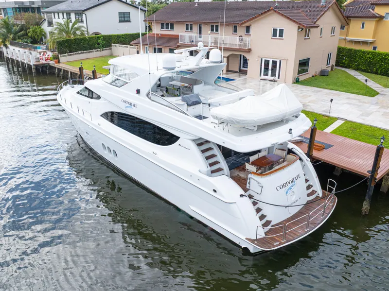Slide: The Image of 2005 Hatteras 80 Motor Yacht docked near waterfront homes. - 3