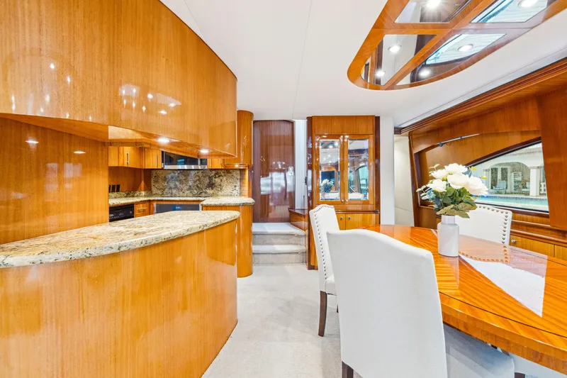 Slide: The Image of Luxurious interior of 2005 Hatteras 80 Motor Yacht with elegant wood finishes and modern dining area. - 34