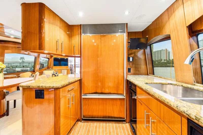 Slide: The Image of Luxurious kitchen interior of 2005 Hatteras 80 Motor Yacht with wood cabinetry and granite countertops. - 37